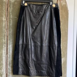 Black leather pencil skirt with suede side panels. Side slits.